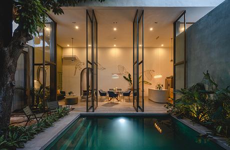 Sleek modern architecture with floor-to-ceiling windows, minimalist decor, and a serene pool.