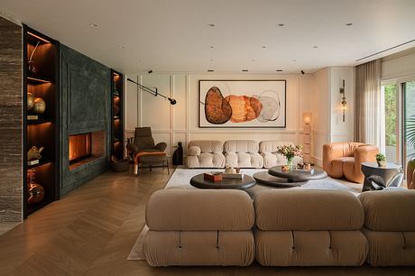 Cozy living room with plush modular seating, wood-paneled fireplace, and abstract artwork.