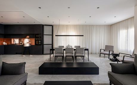 Sleek, modern interior with minimalist furniture, neutral color palette, and recessed lighting.