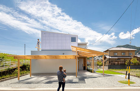 Striking modern house with wooden beams, corrugated metal facade, and large covered patio.