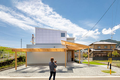 Striking modern house with wooden beams, corrugated metal facade, and large covered patio.