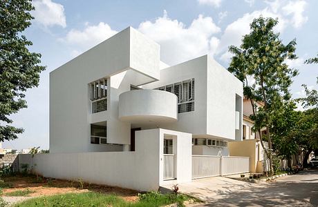 Modern architectural design with geometric shapes, clean lines, and balconies. Unique exterior style.