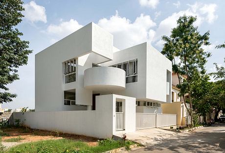 Modern architectural design with geometric shapes, clean lines, and balconies. Unique exterior style.