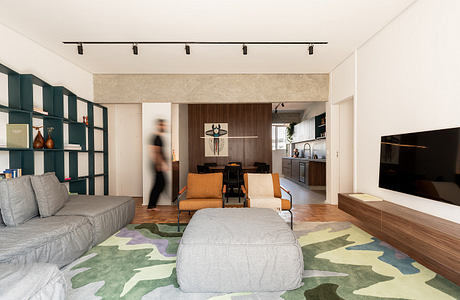 Sleek modern living room with minimalist shelving, warm wood accents, and patterned rug.