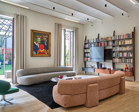 Stylish living room with built-in bookshelves, large artwork, and modern furniture.