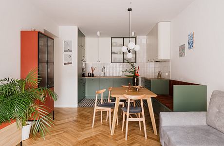 Modern, open-plan kitchen and dining area with geometric patterns, natural wood, and vibrant accents.