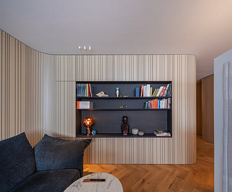 Striking minimalist interior with built-in wood-paneled shelving and modern furniture.