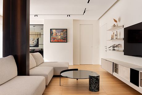 Minimalist living room with sleek furniture, artful decor, and functional lighting design.