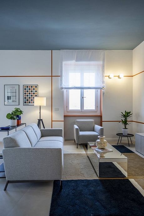 Modern living room with minimalist furnishings, wood accents, and large windows.