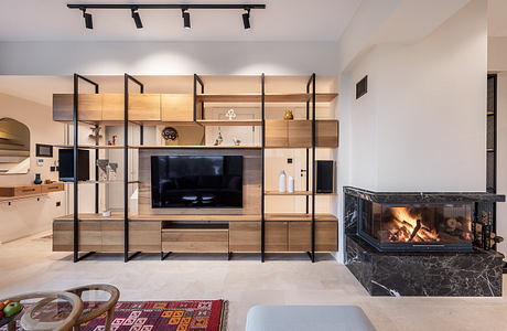 Modern open-concept living room with sleek wooden entertainment unit, fireplace, and track lighting.