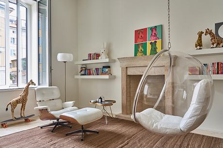 Cozy, modern space with plush chair, hanging bubble chair, and eclectic decor details.