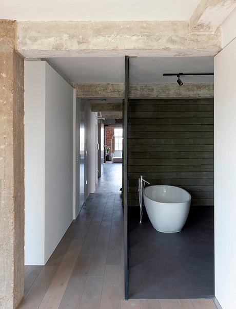 Visually striking mix of raw concrete and sleek modern design elements.