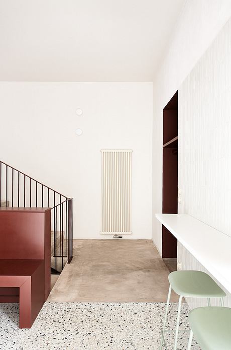 Minimalist interior with warm tones, concrete flooring, and a sleek radiator.