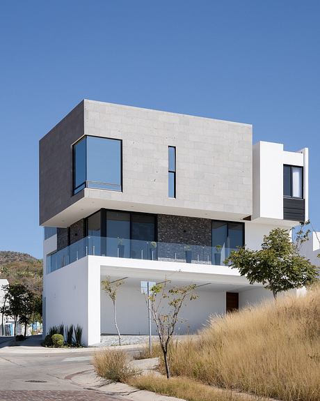 Modern, geometric building with clean lines, large windows, and contrasting materials.