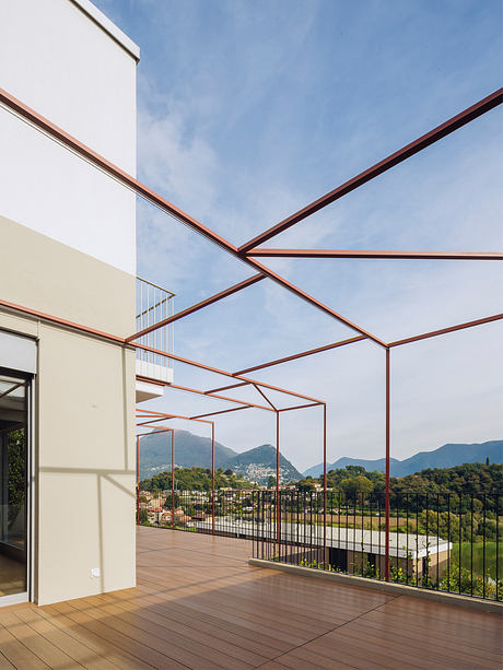 Striking architectural design with intersecting steel beams and expansive views of mountains.