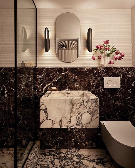 Sleek modern bathroom with dark marble vanity and architectural light fixtures.