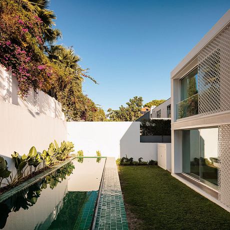 Modern architectural design with lush landscaping, reflecting pool, and spacious layout.