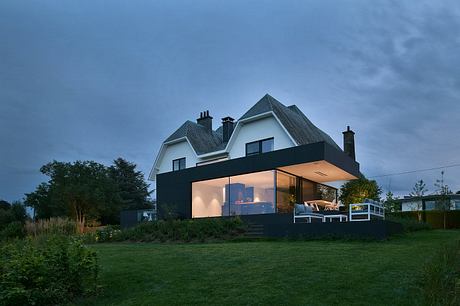 A modern extension with a striking black facade blends seamlessly with the traditional home.