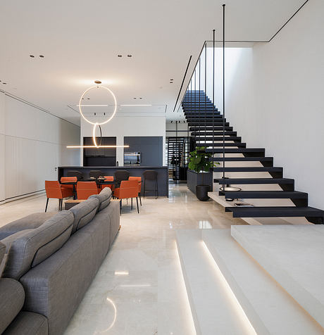 Sleek modern interior with minimalist staircase, open-plan living area, and stylish furniture.