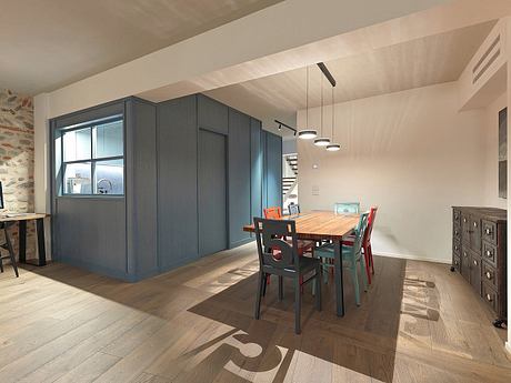 A contemporary kitchen and dining area with sleek gray cabinetry, wooden table, and eclectic seating.