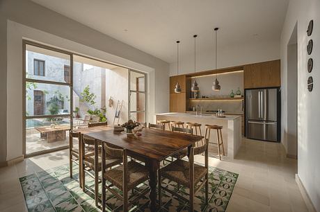 Spacious, open-concept kitchen and dining area with sleek modern design and wooden accents.