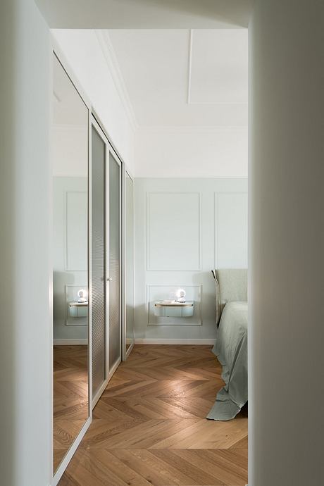 Elegant bedroom with minimalist design, wood flooring, and recessed lighting.