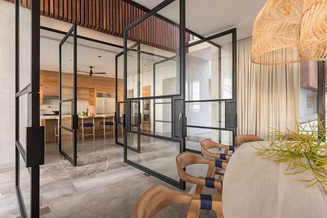 Sleek and modern interior design with glass partitions, wood accents, and plush seating.