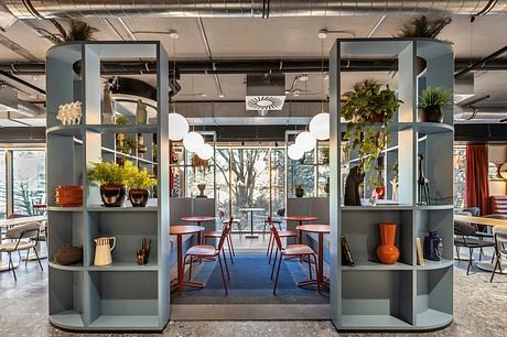 Sleek, modular shelving units frame an inviting lounge space with vibrant decor.