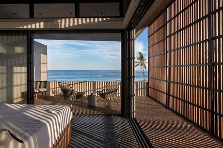 Sophisticated tropical patio with Zen-inspired wood screens and ocean view.