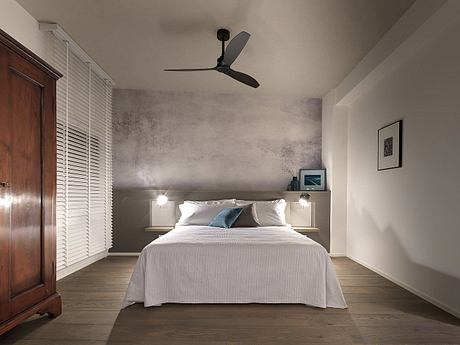 Minimalist bedroom with concrete walls, dark wood furniture, and modern ceiling fan.