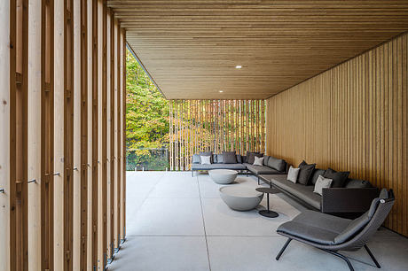 Spacious modern outdoor living area with wooden ceiling, concrete floor, and modular seating.