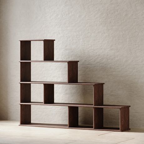 Minimalist dark wooden shelving unit with clean lines and asymmetric arrangement.