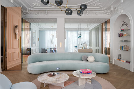 Lavish interior design with ornate ceiling, curved sofa, and marble coffee tables.