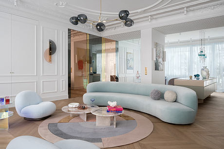 Elegant, contemporary living room with intricate molding, sculptural lighting, and plush furnishings.