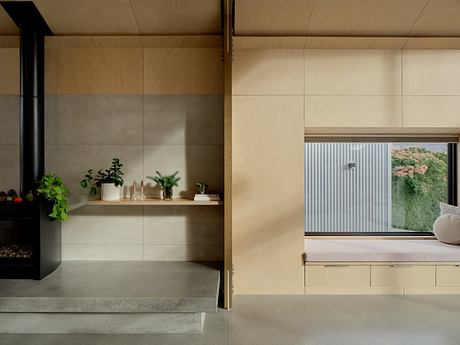 Sleek, minimalist interior with wood and concrete details, and a view through a window.