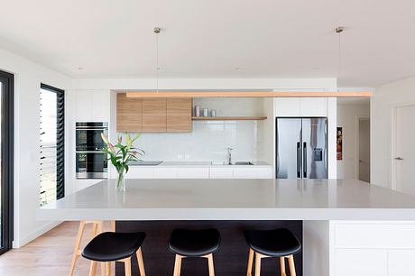 Modern kitchen with clean lines, wooden accents, sleek countertops, and a minimalist aesthetic.
