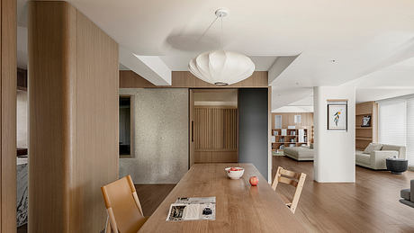 A modern and minimalist dining room with a clean, open layout and warm wood accents.