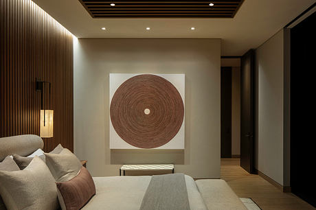 Serene minimalist bedroom with a circular textured artwork panel, wood-paneled walls, and recessed lighting.