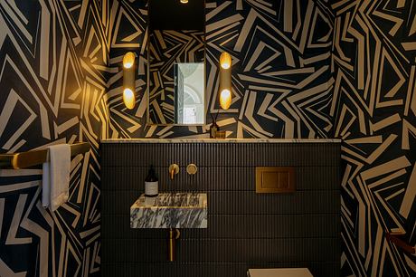 A striking geometric pattern in black and gold enhances the modern bathroom design.