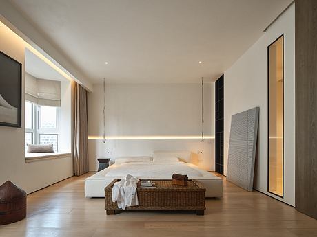 Spacious, modern bedroom with clean lines, warm lighting, and minimalist furniture.