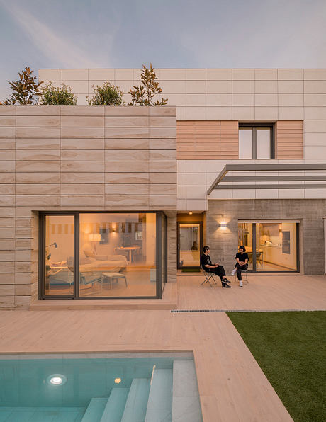 Modern architectural design with large glass windows, pool, and landscaping details.