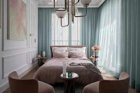 Elegant bedroom with ornate ceiling, plush curtains, and a cozy sitting area.