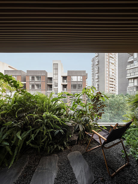 A lush, tropical-inspired garden oasis with modern apartment buildings in the background.