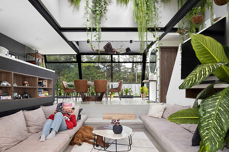 Expansive living space with lush, nature-inspired decor and modern architectural elements.