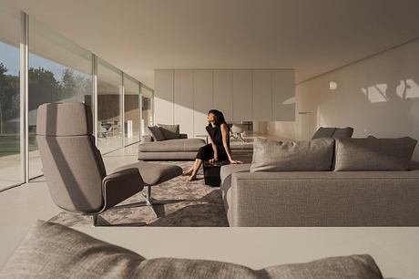 Sleek, modern living room with floor-to-ceiling windows, neutral color palette, and plush seating.