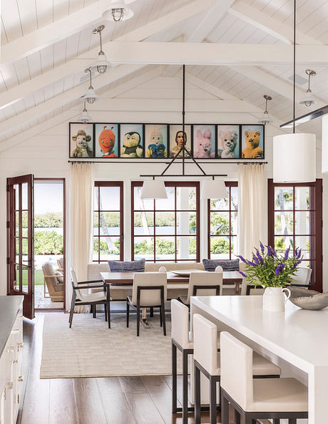 Bright, airy dining room with high ceilings, wood-framed windows, and a unique toy-filled display.