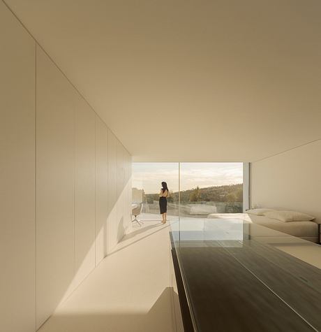 A minimalist interior with expansive glass windows, allowing an unobstructed view of the outdoor landscape.