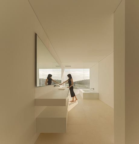 Minimalist bathroom with sleek, modern design, large windows, and floating vanity.