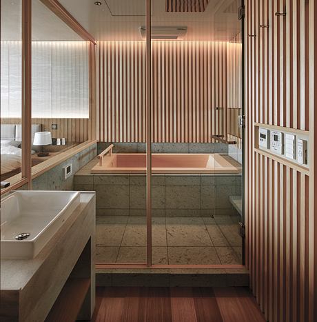 A modern, minimalist bathroom with warm wood accents, marble countertops, and recessed lighting.