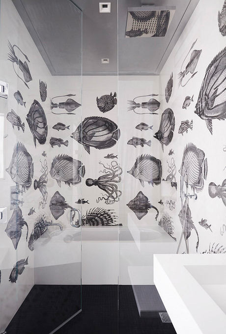 A bathroom with a striking black-and-white fish-themed wallpaper covering the walls.